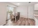 Cozy dining area offers natural light with updated flooring near the kitchen at 4330 Alligator Dr, Venice, FL 34293