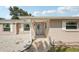 Charming home with neutral siding, decorative stone, and well-manicured landscaping at 4330 Alligator Dr, Venice, FL 34293