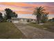 Charming single-story home with a well-manicured front yard and long driveway at 4330 Alligator Dr, Venice, FL 34293