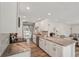 Bright kitchen featuring stainless appliances, granite countertops, and a view into living space at 4330 Alligator Dr, Venice, FL 34293