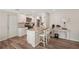 Stylish kitchen boasts a center island with bar seating, stainless appliances, and white cabinets at 4330 Alligator Dr, Venice, FL 34293