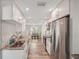 Bright kitchen features stainless steel appliances, granite countertops and white cabinetry at 4330 Alligator Dr, Venice, FL 34293