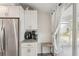 Kitchen area features stainless steel refrigerator, granite countertops, and sliding door to patio at 4330 Alligator Dr, Venice, FL 34293