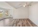 Bright living room with new wood flooring, neutral paint, and a modern ceiling fan at 4330 Alligator Dr, Venice, FL 34293