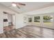 Open concept living area with wood floors, natural light, and connection to the kitchen at 4330 Alligator Dr, Venice, FL 34293