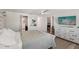 The spacious primary suite features wood floors, a ceiling fan, and ample closet space at 4330 Alligator Dr, Venice, FL 34293