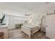 Spacious bedroom featuring wood floors, a ceiling fan, and large windows for natural light at 4330 Alligator Dr, Venice, FL 34293