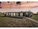 The back exterior of home with a screened lanai, large yard, and serene surroundings at 4330 Alligator Dr, Venice, FL 34293
