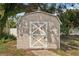 Outdoor shed with white trim and a decorative X pattern on the door at 4330 Alligator Dr, Venice, FL 34293