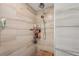 Tile shower showcasing a modern shower head, fixtures, and built-in shelving at 4330 Alligator Dr, Venice, FL 34293