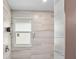 Tiled shower with modern fixtures and a built-in window at 4330 Alligator Dr, Venice, FL 34293