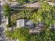 Aerial view of a single-Gathering home with mature trees and an asphalt driveway and a small lot at 520 27Th W St, Bradenton, FL 34205