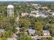 Aerial view featuring the home, surrounding greenery, and Bradenton water tower in the distance at 520 27Th W St, Bradenton, FL 34205