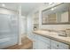 Bright bathroom with a full tub and shower, white cabinetry and large mirror at 520 27Th W St, Bradenton, FL 34205
