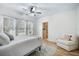 Bright, spacious bedroom with hardwood floors, a ceiling fan, a comfortable chair, and natural light at 520 27Th W St, Bradenton, FL 34205