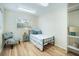 Cozy bedroom with hardwood floors, a twin bed, a window, and built-in storage shelving at 520 27Th W St, Bradenton, FL 34205
