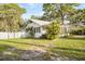 Charming home with white picket fence and manicured lawn, offering a welcoming curb appeal and comfortable living at 520 27Th W St, Bradenton, FL 34205