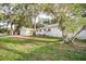 Charming home featuring a detached garage, white siding, and mature trees in a well-maintained yard at 520 27Th W St, Bradenton, FL 34205