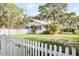 Charming home with a white picket fence, lush lawn, and tasteful landscaping in a serene setting at 520 27Th W St, Bradenton, FL 34205