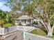 Charming home with white picket fence, lush landscaping, and a welcoming screened-in porch at 520 27Th W St, Bradenton, FL 34205