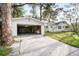 Spacious detached garage with an open door, accessible driveway, and partial view of the house at 520 27Th W St, Bradenton, FL 34205