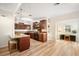Well-lit kitchen with rich wood cabinetry, granite countertops, and an adjacent space for dining or an office at 520 27Th W St, Bradenton, FL 34205