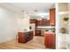 Updated kitchen with wood cabinets, stainless steel appliances, and a central island with granite countertop at 520 27Th W St, Bradenton, FL 34205