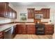 Updated kitchen showcases stainless steel appliances, granite countertops, and custom dark wood cabinetry at 520 27Th W St, Bradenton, FL 34205