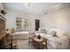 Bright living room showcases neutral decor, stone fireplace, and a view of the home's entrance at 520 27Th W St, Bradenton, FL 34205
