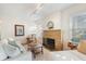 Comfortable living room with stone fireplace, neutral decor, and stylish track lighting at 520 27Th W St, Bradenton, FL 34205
