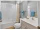 Well-lit bathroom featuring a bathtub, shower, and single sink vanity with storage at 5333 Tide Point Way, Bradenton, FL 34208