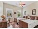 Bedroom featuring hardwood floors, two twin beds, two windows, and a desk at 5333 Tide Point Way, Bradenton, FL 34208