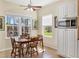Bright eat-in kitchen area features a dining table set and built-in microwave at 5333 Tide Point Way, Bradenton, FL 34208