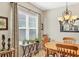 Dining room area with natural light and wooden table and chairs, plants, and chandelier at 5333 Tide Point Way, Bradenton, FL 34208