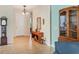 Inviting foyer with neutral tile flooring, stylish console table, grandfather clock and ample natural light at 5333 Tide Point Way, Bradenton, FL 34208