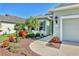 Beautiful single-story home with lush landscaping, palm trees, and a well-manicured lawn at 5333 Tide Point Way, Bradenton, FL 34208