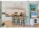 Modern kitchen with bar seating, white cabinetry, stainless steel appliances, and a stylish backsplash at 5333 Tide Point Way, Bradenton, FL 34208