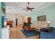 Comfortable living room with tile floors, tray ceiling, and views of the foyer, kitchen, and living spaces at 5333 Tide Point Way, Bradenton, FL 34208