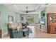 Bright and airy living room featuring a tray ceiling, tile flooring, and views of the outdoor pool at 5333 Tide Point Way, Bradenton, FL 34208