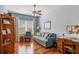 Inviting living room with blue walls, hardwood floors, ceiling fan, and a comfortable sofa at 5333 Tide Point Way, Bradenton, FL 34208