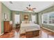 Serene bedroom featuring hardwood floors, ceiling fan, and a cozy, inviting feel at 5333 Tide Point Way, Bradenton, FL 34208