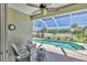 Relaxing screened-in lanai overlooking a sparkling pool and manicured backyard with palm trees at 5333 Tide Point Way, Bradenton, FL 34208