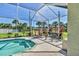 Screened-in pool area with patio seating and a lush garden view at 5333 Tide Point Way, Bradenton, FL 34208