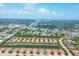 An aerial view of a neighborhood featuring a beautiful pond, lush landscaping, and well-maintained homes at 5863 Cavano Dr, Sarasota, FL 34231