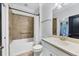 Bathroom features a shower/tub combination, vanity with a sink, and neutral tile at 5863 Cavano Dr, Sarasota, FL 34231