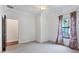 Bright bedroom with carpeted floors, ceiling fan, and window with stylish red floral curtains at 5863 Cavano Dr, Sarasota, FL 34231