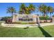 Stone sign at Esplanade community entrance, surrounded by palm trees and colorful landscaping at 5863 Cavano Dr, Sarasota, FL 34231
