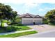 Beautiful home with a brick driveway, well-manicured lawn, and a two-car garage at 5863 Cavano Dr, Sarasota, FL 34231