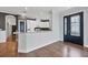 Open kitchen with modern white cabinetry, breakfast bar, and stainless steel appliances at 5863 Cavano Dr, Sarasota, FL 34231