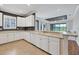 Spacious kitchen features all-white cabinetry, countertops, tile floors, and a breakfast bar at 5863 Cavano Dr, Sarasota, FL 34231